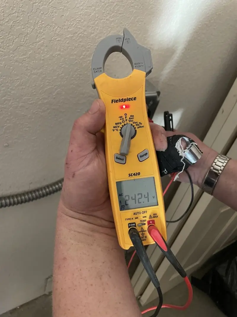 Voltage testing with clamp meter during Recessed Lighting Installation in Evans